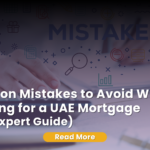 Close-up of a hand holding a blue pen over a mortgage application form, with a "REJECTED" red stamp clearly visible on the document.